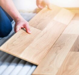 Person installing laminate flooring in tallahassee