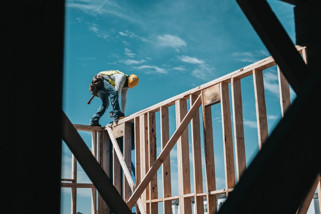 Construction crew framing a new home with wood studs