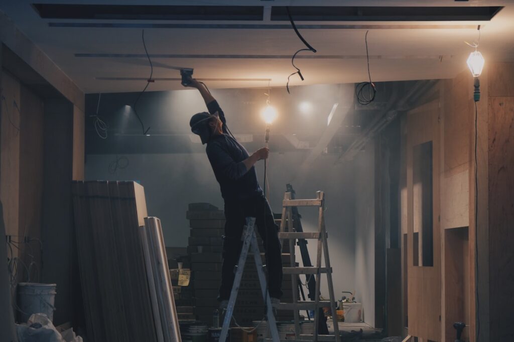 Drywall contractor finishing wall panels during a renovation