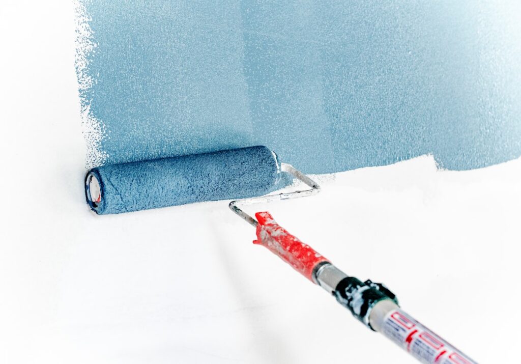 Painter applying fresh paint to an interior wall